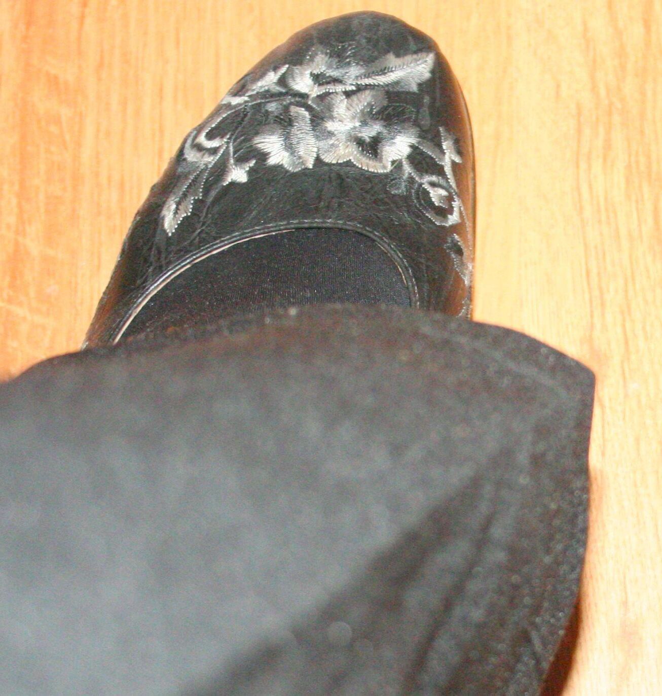 legs in tights with traces of cum in the shoes