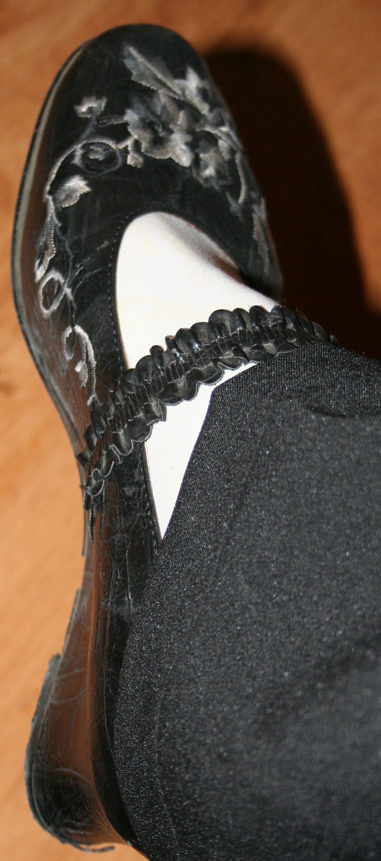 legs in tights with traces of cum in the shoes