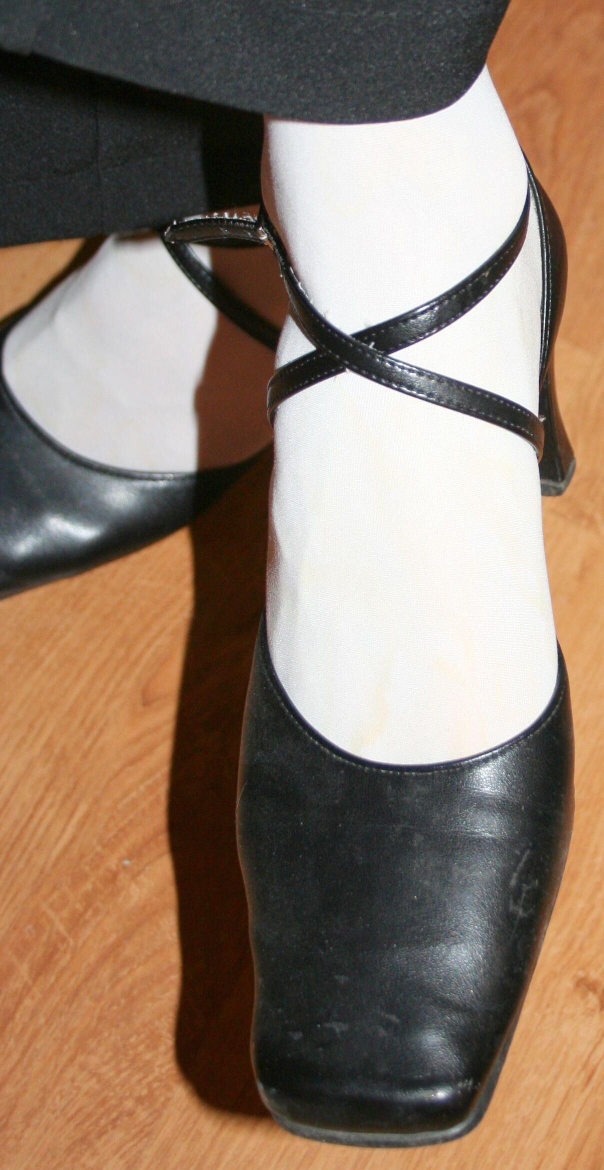 legs in tights with traces of cum in the shoes