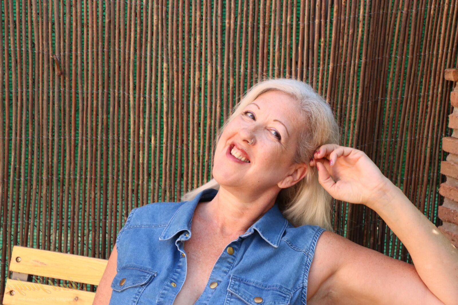 Maggie Moon yo Soaks Up Sun and Plays on an Outdoor Bench