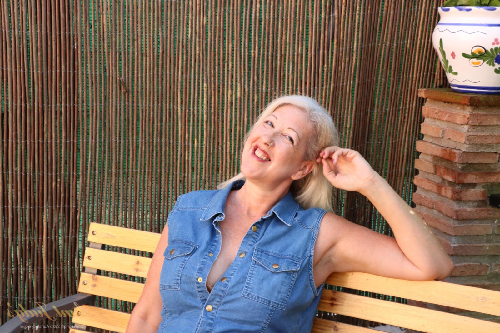 Maggie Moon yo Soaks Up Sun and Plays on an Outdoor Bench