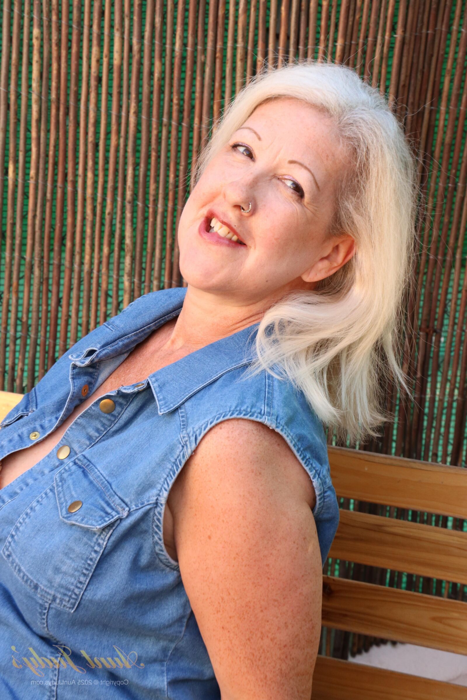 Maggie Moon yo Soaks Up Sun and Plays on an Outdoor Bench