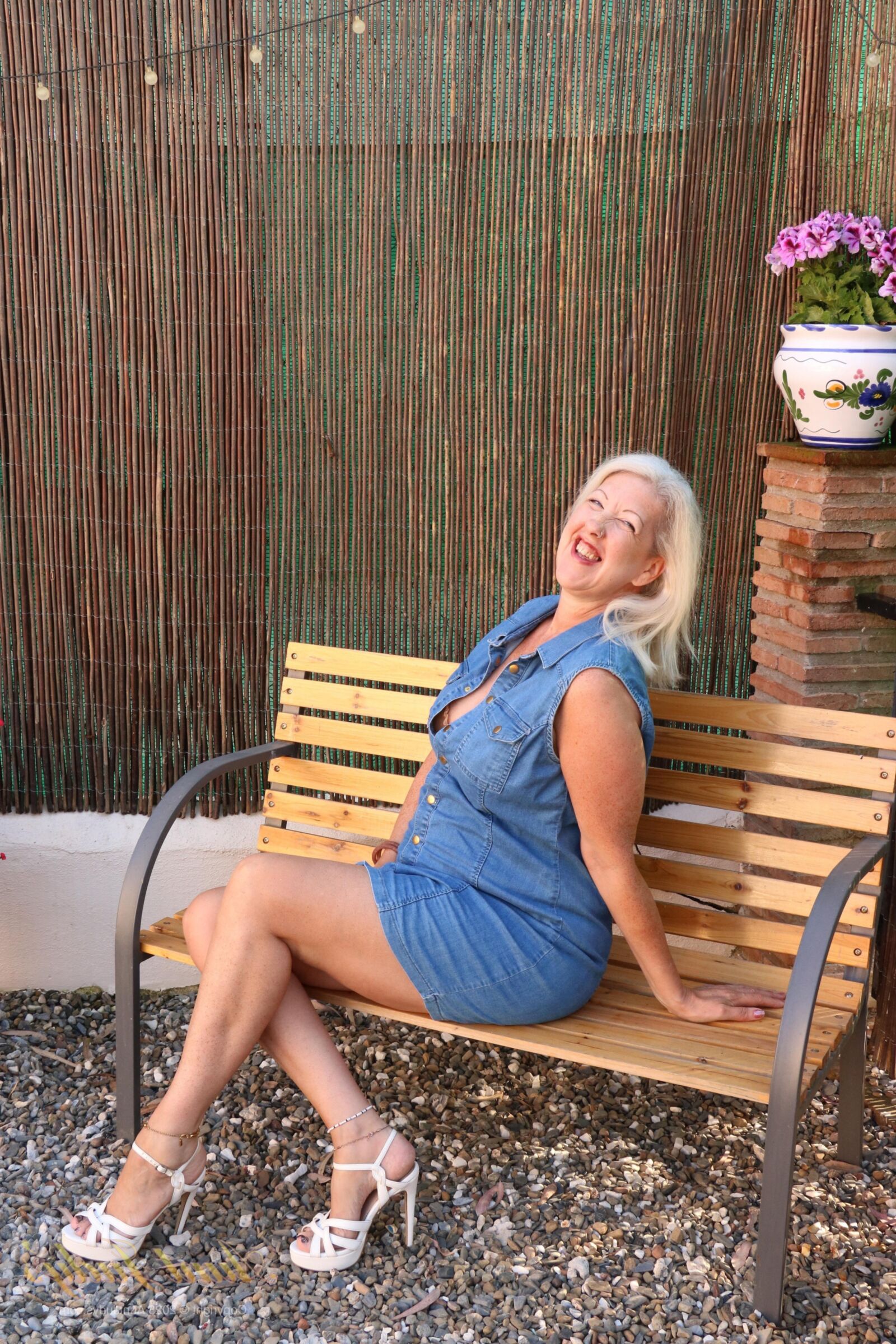 Maggie Moon yo Soaks Up Sun and Plays on an Outdoor Bench